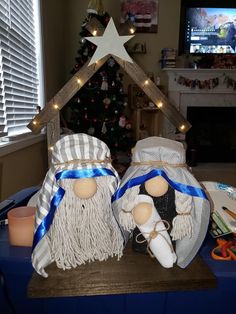 two christmas figurines sitting on top of a table