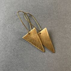 Simple but elegant hammered brass triangle earrings. Gold Triangle Minimalist Earrings, Minimalist Gold Triangle Earrings, Gold Triangle Brass Jewelry, Triangle Gold Metal Earrings, Gold Triangle Metal Earrings, Everyday Gold Triangle Earrings, Triangle Earrings, Bees Knees, Hand Stamped