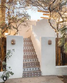 an outdoor staircase with tiled steps leading up to the house