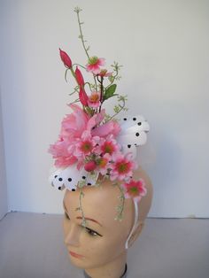 "* This pleated polka dot hat base has a 8\" diameter featuring an open pink silk peony, open roses, closed tulips and summer greens. * White millinery netting hides the underside of the hat base form and adds just a touch of texture variety and drama to the piece. * On a metal headband with a satin ribbon covering it is secure, well balanced and comfortable to wear for extended periods of time. * Upon ordering you will receive this exact headpiece. * Perfect for the Kentucky Derby or any other Spring Flower-shaped Fitted Fascinator, Fitted Whimsical Mini Hats For Spring, Whimsical Fitted Fascinator For Spring, Fitted Whimsical Spring Fascinator, Whimsical Fitted Headpieces For Spring, Spring Flower Hats For Races, Spring Races Flower Hat, Whimsical Spring Fascinator For Races, Pink Flower Mini Hat For Garden Party