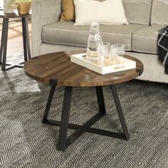 a coffee table with glasses on it in front of a couch