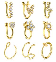 six pairs of gold nose rings with crystal stones on each side and the letter c