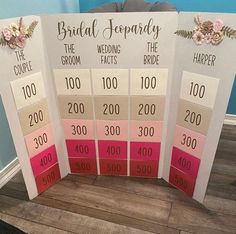 four wedding cards with the names of each bride and groom on them, sitting on a wooden floor