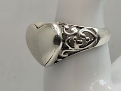 This is a lovely silver filagree heart ring in size 7.75 East Village Bangles is the product of love ❤️, a unique collection of vintage jewelry painstakingly restored by Casey in the East Village. Ours is a people business as much as a jewelry business. Even as we put love, sweat (and sometimes tears!) into restoring these items, it is our policy that you must be thrilled. We stand behind every item and we will take it back if it is not for you. Classic Silver Heart-shaped Ring, Classic Silver Heart Shaped Ring, Antique Heart-shaped Promise Ring, Classic Silver Heart Ring For Gift, Vintage Silver Rings For Valentine's Day, Silver Heart-shaped Engraved Promise Ring, Vintage Engraved Heart Ring, Vintage Silver Heart Ring For Gift, Classic Heart-shaped 925 Stamped Rings