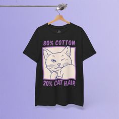 ✦ OUR PRODUCT Cat owners, this one's for you! Show off your sense of humor with this fun 80% Cotton, 20% Cat Hair t-shirt. Featuring a winking cat and a playful nod to the inevitable cat hair that comes with owning a feline friend, this design is perfect for all the proud cat parents out there. Made from durable 100% US cotton, this unisex tee is comfortable, stylish, and bound to get a few laughs. Whether you're lounging at home with your cat or out and about, this shirt is the perfect way to embrace life with cats! 🐈💕 ✦ GARMENT DETAILS * 100% US cotton  * DTG printing * Fabric weight :5.0-5.3 oz/yd² (170-180 g/m²) * Regular fit : Standard length, the fabric easily give into movement * Pre-shrunk jersey knit * Taped neck and shoulders * Double seam at sleeves and bottom hem * Tear-away Cotton Graphic Tee With Cat Print, Crew Neck Cotton Shirt With Cat Design, Cotton Crew Neck Shirt With Cat Design, Short Sleeve Graphic Tee With Cat Design, Cotton T-shirt With Cat Design, Relaxed Fit, Cotton Cat Print Tops For Streetwear, Cotton Tops With Cat Print For Streetwear, Cotton Short Sleeve Top With Cat Design, Cotton Short Sleeve T-shirt With Cat Design