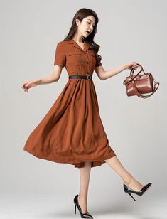 "This stunning brown shirt dress is a versatile piece that can be dressed up or down depending on the occasion. Featuring elegant pleats, this dress is perfect for both work and play. The short sleeves make it perfect for warmer weather, while the brown color gives it a classic look that will never go out of style. Pair it with heels for a sophisticated office look or sandals for a casual day out. DETAIL * The brown dress contain 50% polyester, others are nylon,fiber * Has no pockets * Right sid Brown Summer Dresses With Buttons, Brown Buttoned Summer Dresses, Brown Fitted Mid-length Dress, Fitted Mid-length Brown Dress, Office Lady Style Dress With Button Closure For Spring, Brown Workwear Dress With Pockets, Elegant Brown Belted Midi Dress, Short Sleeve Midi Dress With Button Closure For Fall, Short Sleeve Maxi Dress With Buttons For Workwear