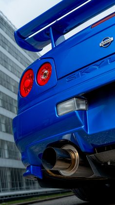 the rear end of a blue sports car