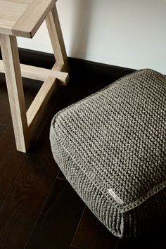 a chair and footstool sitting on the floor