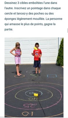 two children are standing in front of a chalk drawing on the ground with numbers and letters