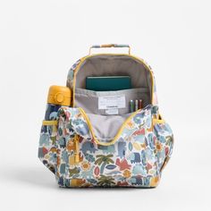 A backpack that's extra comfy and ready to handle all the adventures of the day. Decorated with colorful dino pals, a lush landscape and cheery yellow trim, this kids' medium knapsack is constructed of supremely durable polyester fabric that includes recycled plastic bottles. A roomy interior holds everything your kid needs-books, school supplies, extra layers-and there's a padded pocket to keep their tablet protected. Outside pockets hold snacks, water bottles and more. Pair this book bag with Playful Yellow Backpack For Back To School, Target Toddler Backpack, Back To School Travel Backpack With Character Print, Kids Hiking Backpack, Toddler Boy Backpack, Kids Pencil Case, Personalized Backpack Kids, Kindergarten Backpack, Extra Outfits