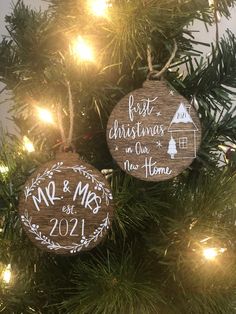 two wooden ornaments hanging from a christmas tree