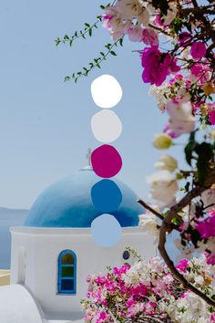 a blue dome with white and pink flowers around it