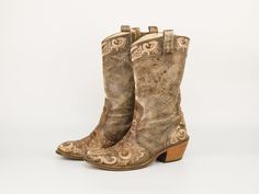 Step into Western charm with these Vintage All Leather Cowboy pull on Boots in Tan Brown by Kobra. Handmade in Italy, these cowgirl ankle boots feature intricate embroidery and a distressed finish for an authentic look. The medium heel and pull straps ensure comfort and ease of wear. Crafted from high-quality leather, these boots combine durability with timeless style, making them perfect for any cowgirl's wardrobe. Without any side zipper.  Brand: Kobra | Made in Italy Condition: USED. Stains, Western Beige Embroidered Boots, Western Embroidered Beige Boots, Embroidered Beige Western Boots, Cowgirl Ankle Boots, Thick Heel Boots, Cowboy Vintage, Genuine Leather Boots, Vintage Cowboy, Pointed Toe Boots