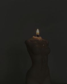 a candle that is lit in the dark