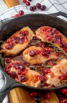 chicken with cranberry sauce in a cast iron skillet