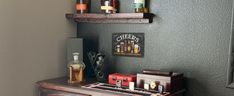 there are two shelves on the wall with liquor bottles and an old fashioned organ in it