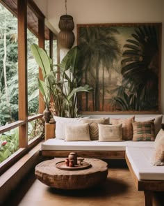 a living room filled with lots of furniture next to a large painting on the wall