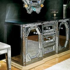 an ornate mirrored cabinet in the corner of a room