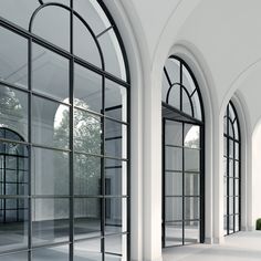 an empty room with arched windows and white walls