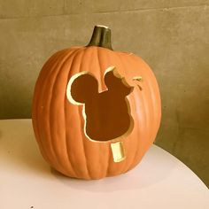 a mickey mouse pumpkin sitting on top of a table