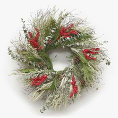 a christmas wreath with red berries and greenery