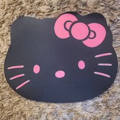 an image of a hello kitty mouse pad on the floor