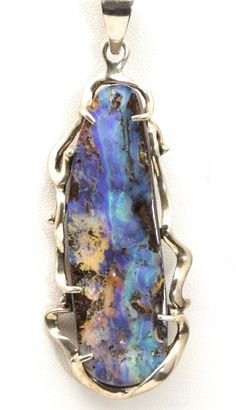 Artisan Modern Huge Boulder Opal Pendant-Handcrafted freeform, modern design Sterling silver setting-A very large, multi colored elongated oval boulder opal-Large bail will accommodate most chains with opening of 10mm x 8mm-Signed/Stamped "925" on the top of the bail, although it is difficult to read. Piece tests positive with silver acid test.-Pendant measures 3" long (not including the bail) x 1.3" wide, depth of pendant .35"-Opal stone measures 66mm x 20mm at the longest/widest points-Total w Boulder Opal Jewelry, Jewelry Pictures, Wire Wrap Jewelry Designs, Elongated Oval, Boulder Opal Pendant, Opal Pendant Necklace, Jewelry Picture, Wrap Jewelry, Stone Work