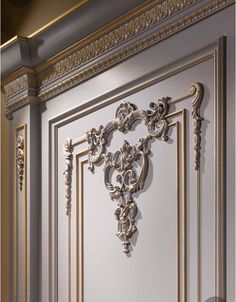 an ornate gold and white door with decorative carvings on the front panel, in a room