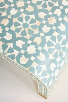 a blue and white table with geometric designs on it