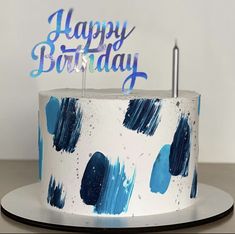 a blue and white birthday cake with the words happy birthday on it's top