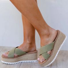 The perfect sandals to match your fit of choice are our Sunkissed Sage Slide-On Raffia Sandals! Featuring a raffia-wrapped platform wedge, vegan suede fabric that covers a wide crisscrossing toe band, and a slide-on silhouette. Wear these sandals to complement your favorite outfit! Spring Beach Suede Wedge Sandals, Fabric Wedge Sandals With Round Toe For Vacation, Suede Wedge Sandals For Summer Beach, Suede Wedge Sandals For Beach In Summer, Summer Open Toe Suede Platform Slippers, Summer Suede Open Toe Platform Slippers, Suede Wedge Sandals For Vacation, Suede Platform Wedge Sandals For Vacation, Trendy Suede Wedge Sandals For Summer