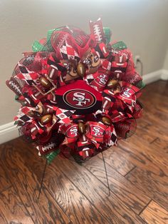 a football wreath with the san francisco giants on it sitting on top of a hard wood floor