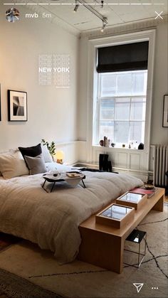 a bedroom with a large bed in the middle and pictures on the wall above it