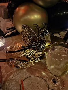 a table topped with balloons and wine glasses