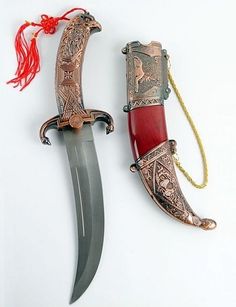 two different types of knifes with red handles and gold accents on each one side