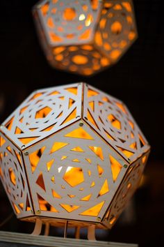 two white lanterns with intricate designs on them