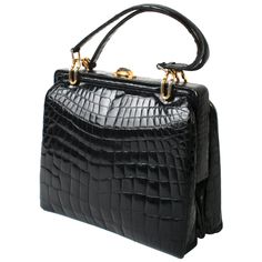 Black alligator handbag with matching double straps and gold-tone link hardware. It has double accordion construction, a two-tone push-button closure and a wide hinged opening. The purse is lined in a soft tan suede with two alligator lined side pockets and an accordion zipper pocket. No labels. Measures 16.5"H to top of straps x 11"W x 5"D. N. P. Trent Antiques has been a respected name in antiques for over 30 years with a large collection of period furniture, art, books, jewelry and decorative Bag Logo Design, Alligator Purse, Alligator Handbags, Bag Logo, Black Alligator, Ladies Bag, Trendy Handbags, Gold Handbags, Best Handbags