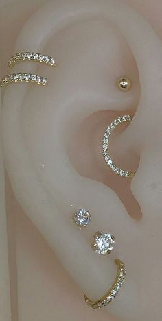 three different types of ear piercings with diamonds