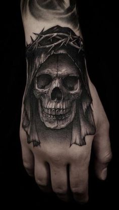 a hand with a skull and crown on it