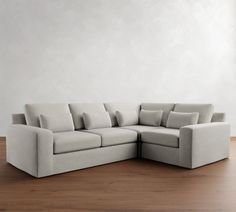 a white couch sitting on top of a wooden floor