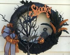 a halloween wreath with black and orange decorations