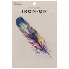 a package of iron on stickers with a colorful bird's feather in the center