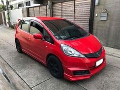 a red car parked on the side of a street