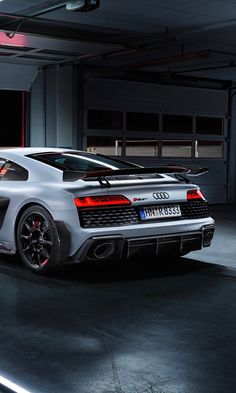 a silver sports car parked in a garage