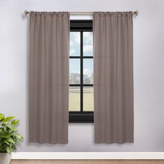 an open window with a curtain and potted plant