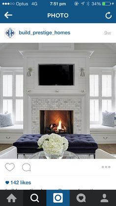 a living room filled with furniture and a fire place next to a tv mounted above a fireplace