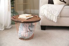 a table that has some books on top of it in front of a couch and chair