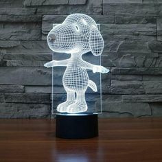 a 3d dog lamp sitting on top of a wooden table