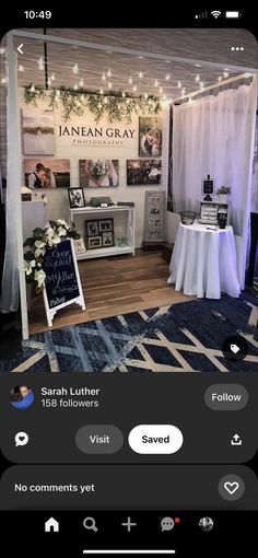 an image of a booth with pictures on the wall and lights strung from the ceiling