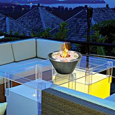 a fire pit sitting on top of a glass table